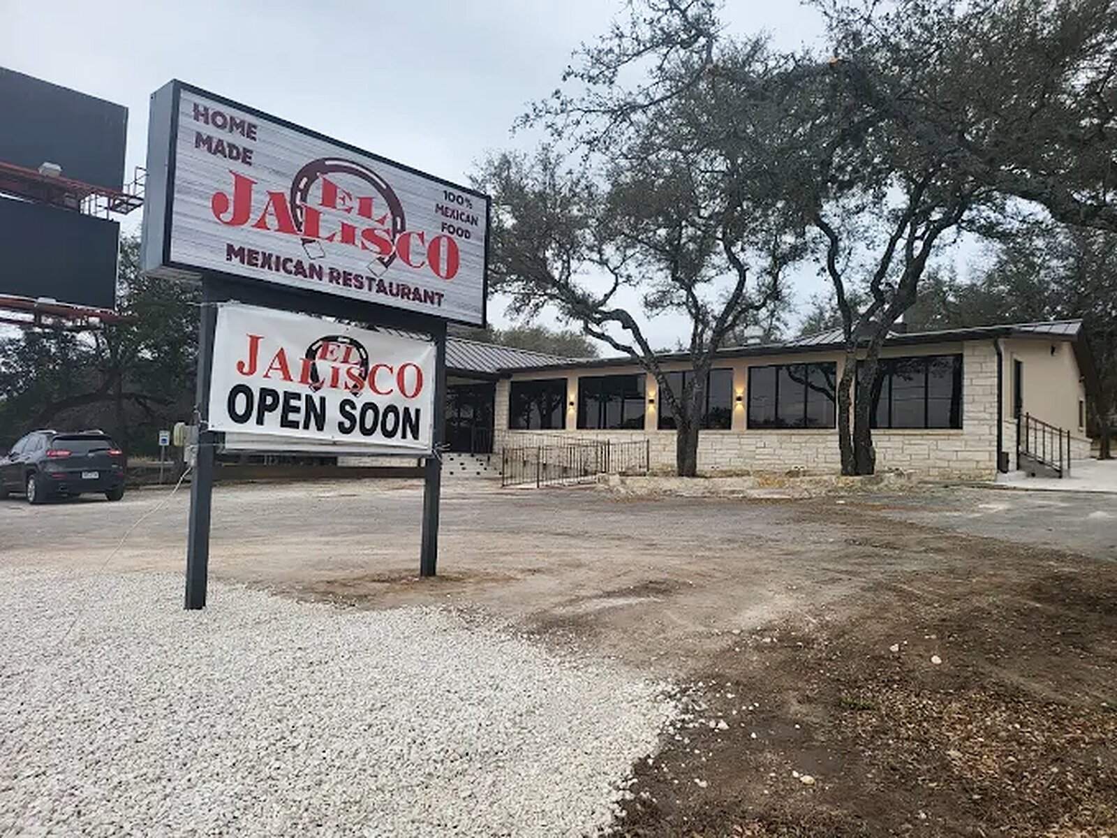 A second El Jalisco building with an Open Soon sign at the road