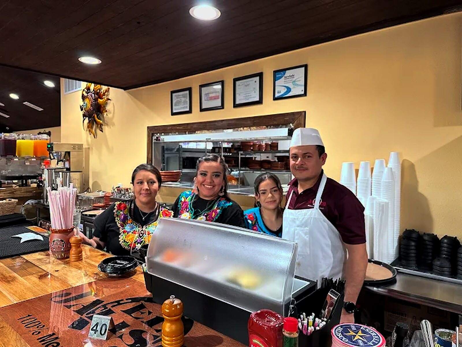 Four members of the El Jalisco #3 team behind the front counter
