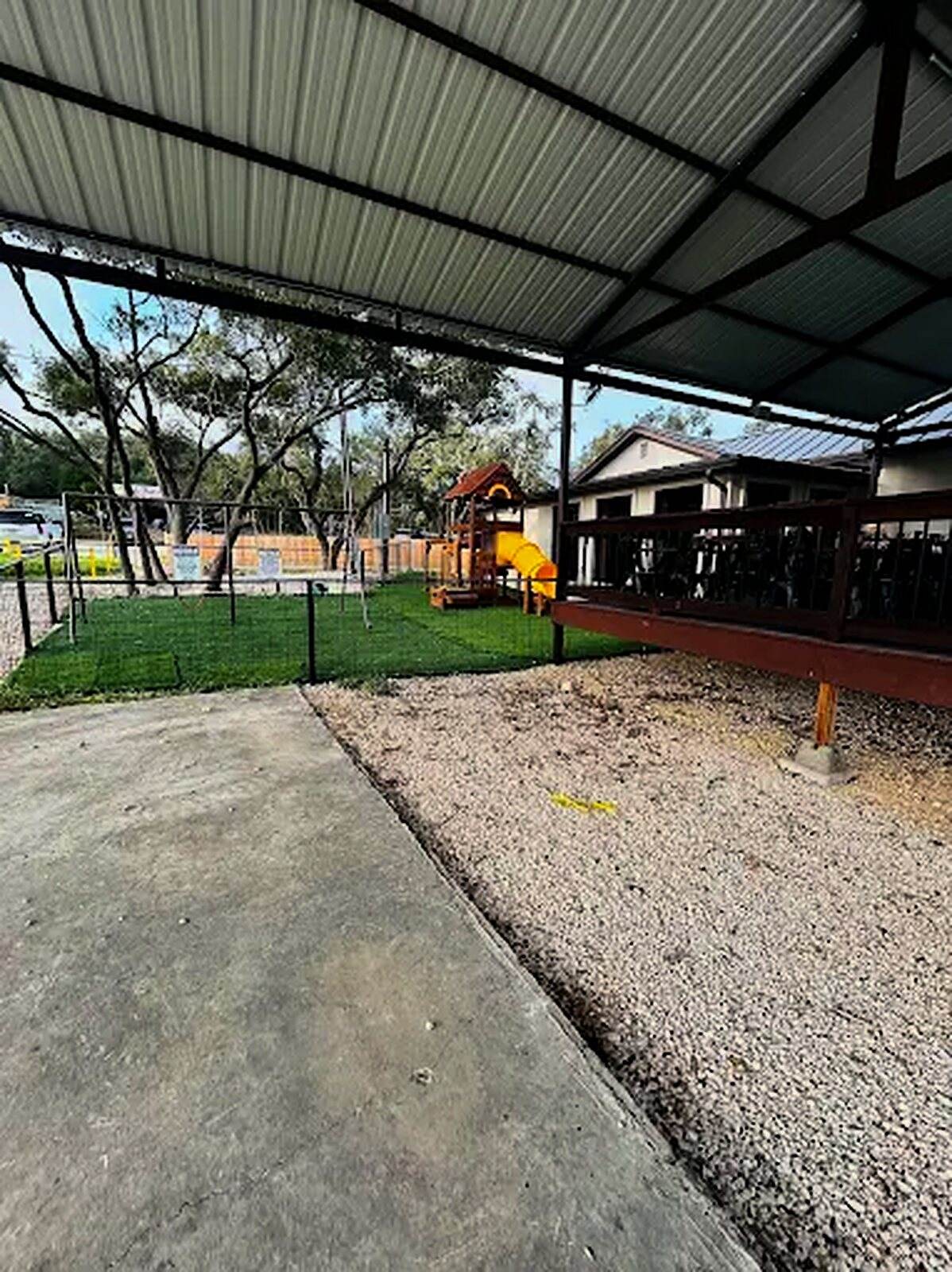 The covered patio looking out to the playground and the live oaks behind the restaurant